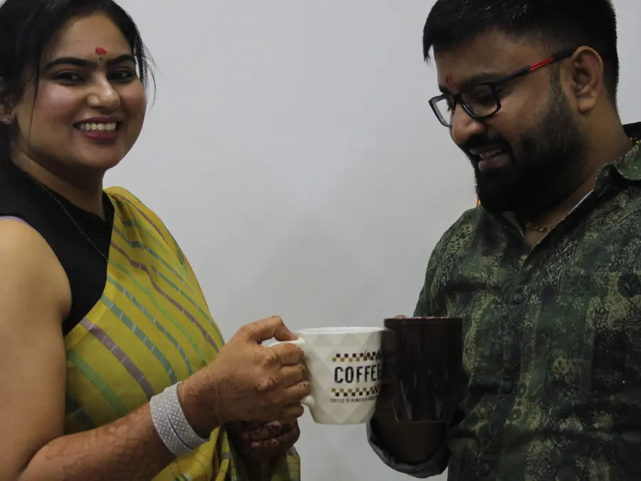 Two colleagues raising mugs in the office
